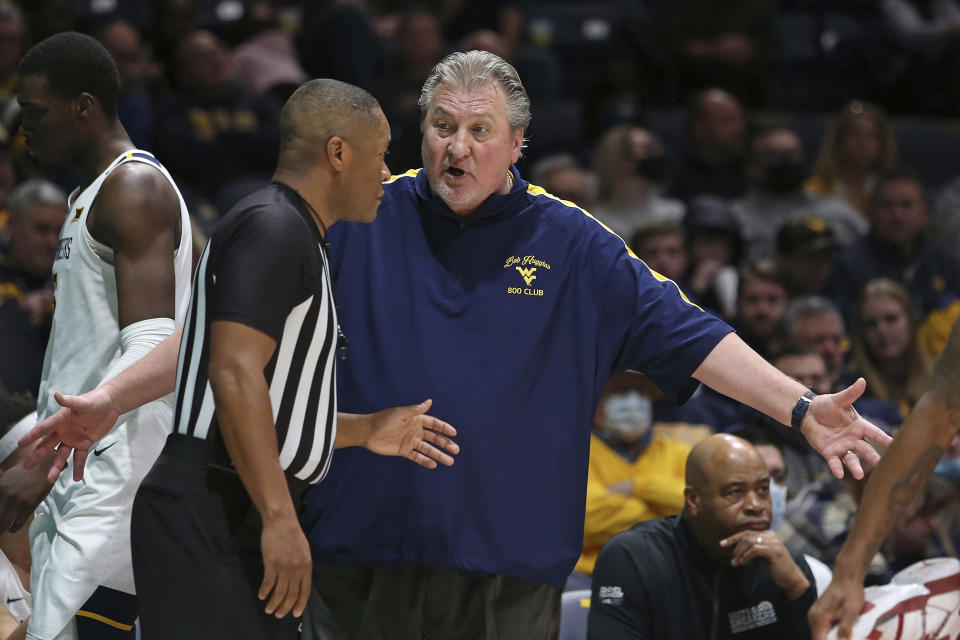 West Virginia coach Bob Huggins speaks with an official during the first half of an NCAA college basketball game against Oklahoma in Morgantown, W.Va., Wednesday, Jan. 26, 2022. (AP Photo/Kathleen Batten)