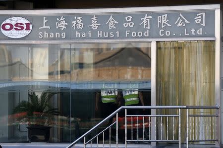 Security guards stand inside the Husi Food factory in Shanghai July 23, 2014. REUTERS/Aly Song