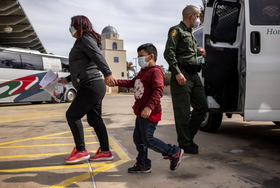 Central American asylum seekers arrive to a bus station while being released by US Border Patrol agents on 26 February, 2021 in Brownsville, Texas.Getty Images