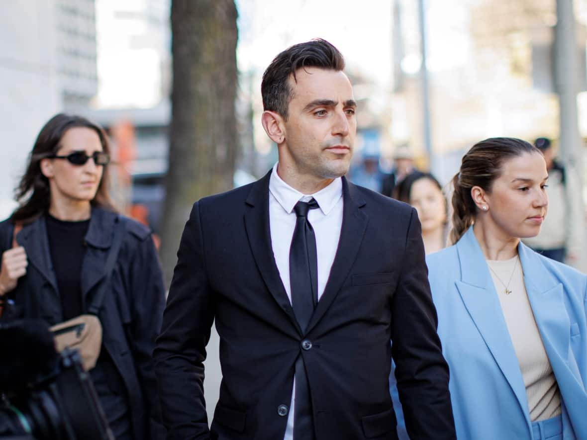 Former Hedley frontman Jacob Hoggard and his wife, Rebekah Asselstine, leave court in Toronto on May 4, after the jury in Hoggard’s sex assault trial was selected. (Evan Mitsui/CBC - image credit)