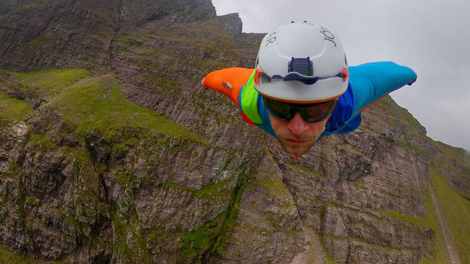 A brave base jumper has become the first person ever to fly a wingsuit from the top of a British mountain. Former Royal Marine Tim Howell, 31, leapt from the 4,000ft peak of An Teallach in the northwest Highlands in Scotland. He plunged down a steep gully for 30 seconds before deploying his parachute and landing safely on the banks of Loch Toll an Lochain.