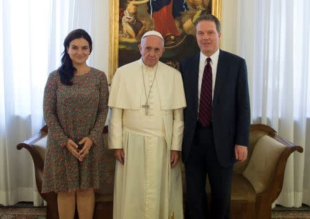 Pope Francis poses with Vatican spokesman Greg Burke (R) and deputy Vatican spokesperson Paloma Garcia Ovejero during a meeting at the Vatican in this undated handout. Media/Handout via REUTERS