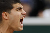 Spain's Carlos Alcaraz shouts as he wins the fourth set against Spain's Albert Ramos-Vinolas during their second round match of the French Open tennis tournament at the Roland Garros stadium Wednesday, May 25, 2022 in Paris. (AP Photo/Jean-Francois Badias)
