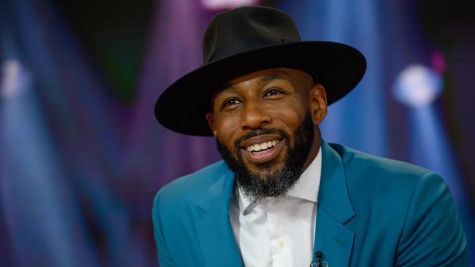 Stephen "DJ tWITCH" Boss Wearing Teal Blazer, White Shirt And Hat