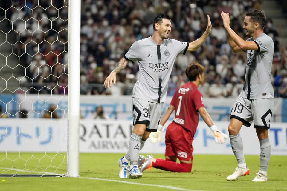 Paris Saint-Germain's Lionel Messi celebrates his goal with his teammate Pablo Sarabia during a friendly soccer match between Paris Saint-Germain and Gamba Osaka in Suita, western Japan, Monday, July 25, 2022. (AP Photo/Hiro Komae)