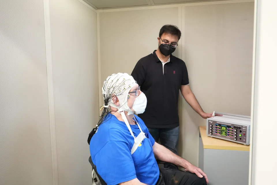 Boston University PhD candidate Shrey Grover administers brain stimulation to study volunteer Jim Soter.