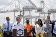 Transportation Secretary Pete Buttigieg, second from left, speaks during a press conference to mark the full reopening of the Port of Baltimore after the collapse of the Francis Scott Key Bridge in March, Wednesday, June 12, 2024, at the Port of Baltimore in Dundalk, Md. (AP Photo/Mark Schiefelbein)