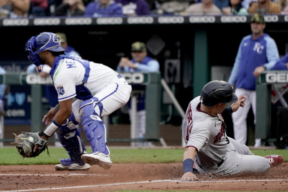 Minnesota Twins' Gio Urshela beats the tag by Kansas City Royals catcher MJ Melendez to score on a sacrifice fly by Byron Buxton during the third inning of a baseball game Saturday, May 21, 2022, in Kansas City, Mo. (AP Photo/Charlie Riedel)