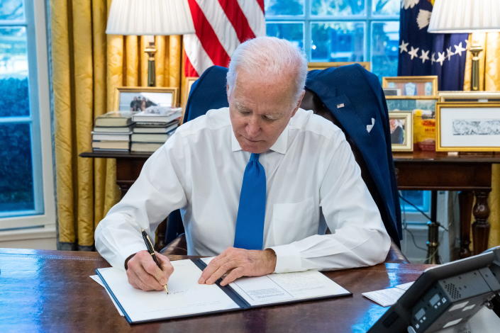 U.S. President Joe Biden signs an executive order to prohibit trade and investment between U.S. individuals and the two breakaway regions of eastern Ukraine recognized as independent by Russia, at the White House in Washington, U.S., February 21, 2022. The White House/Handout via REUTERS THIS IMAGE HAS BEEN SUPPLIED BY A THIRD PARTY.