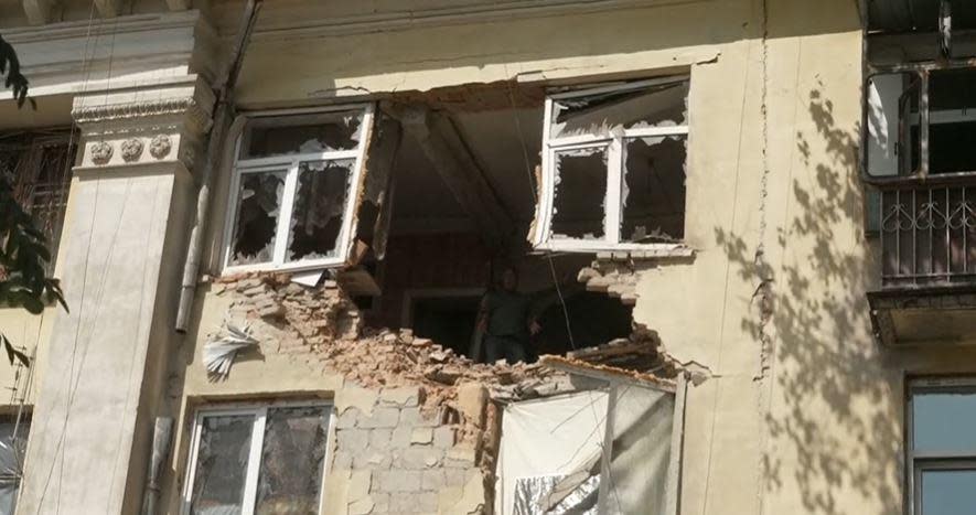 CBS News senior foreign correspondent Charlie D'Agata is barely visible inside a heavily damaged apartment in Marhenets, Ukraine, several days after it was hit by a Russian rocket.  / Credit: CBS News