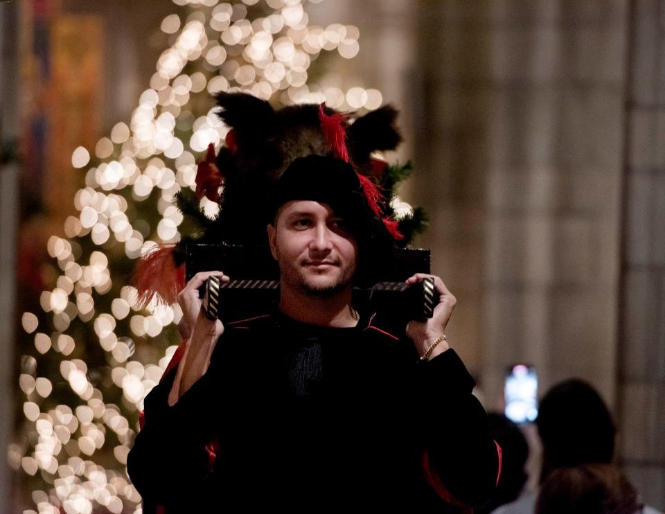 Marko Bartolone serves as a Boar's Head page during the 2024 Boar's Head and Yule Log Festival on Saturday.