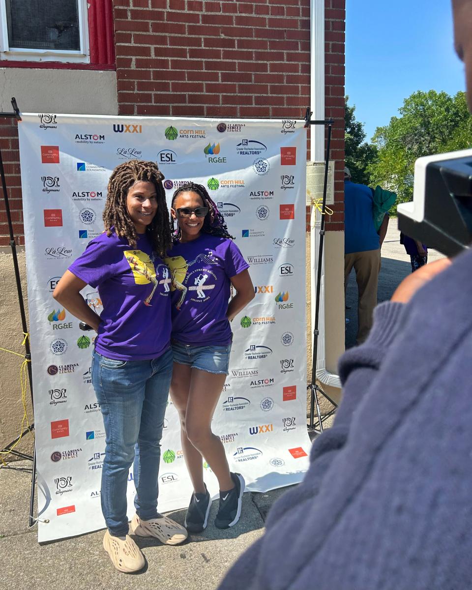 Renee Long (left) and Shalom Singer pose while Terrell Brooks takes a Polaroid picture at the the 25th Annual Clarissa Street Reunion.