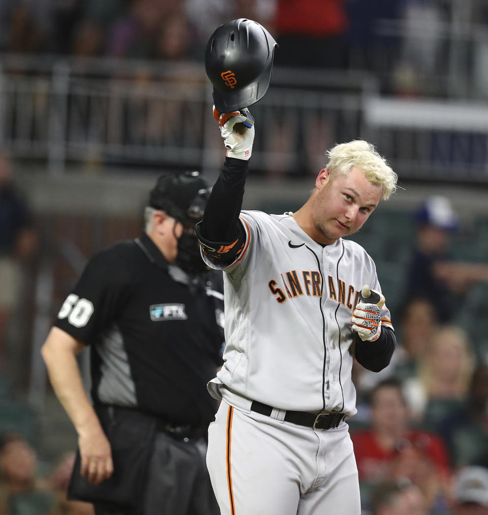 Former Atlanta Braves outfielder Joc Pederson, who received his World Series ring from the Braves in a pre-game ceremony, tips his helmet to cheering Braves fans as he enters the game during the ninth inning to bat in on Monday, June 20, 2022, in Atlanta. (Curtis Compton/Atlanta Journal-Constitution via AP)