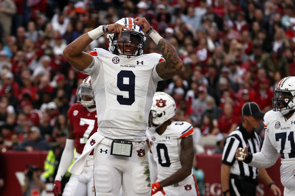 Auburn quarterback Robby Ashford (9) celebrates after scoring a touchdown against Alabama during the first half of an NCAA college football game Saturday, Nov. 26, 2022, in Tuscaloosa, Ala. (AP Photo/Butch Dill)