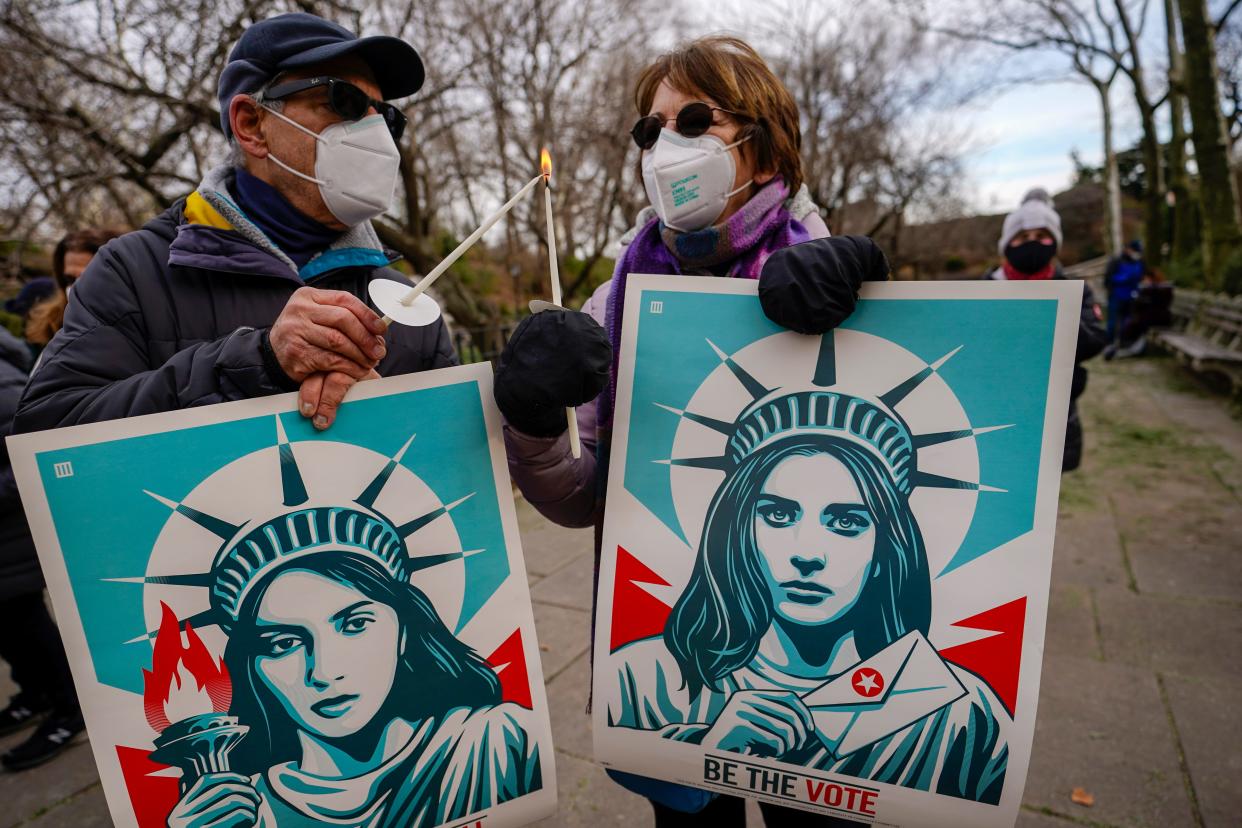 New Yorkers participate in a "January 6 Vigil for Democracy," on Jan. 6, 2022, on the Upper East Side of Manhattan. Ceremonies and vigils were held across the nation to mark the first anniversary of the attack on the U.S. Capitol by supporters of Donald Trump.