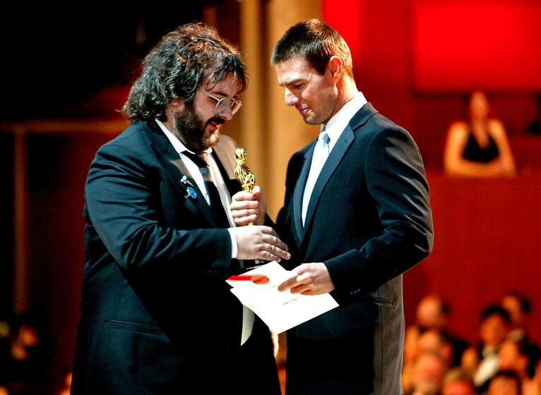 Director Peter Jackson accepts the Best Director award from Tom Cruise at the 76th Academy Awards in 2004.