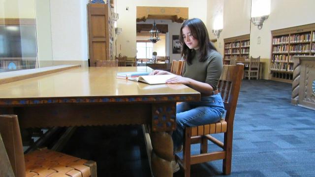 Abrianna Morales studies in a library on the campus of the University of New Mexico in Albuquerque.
