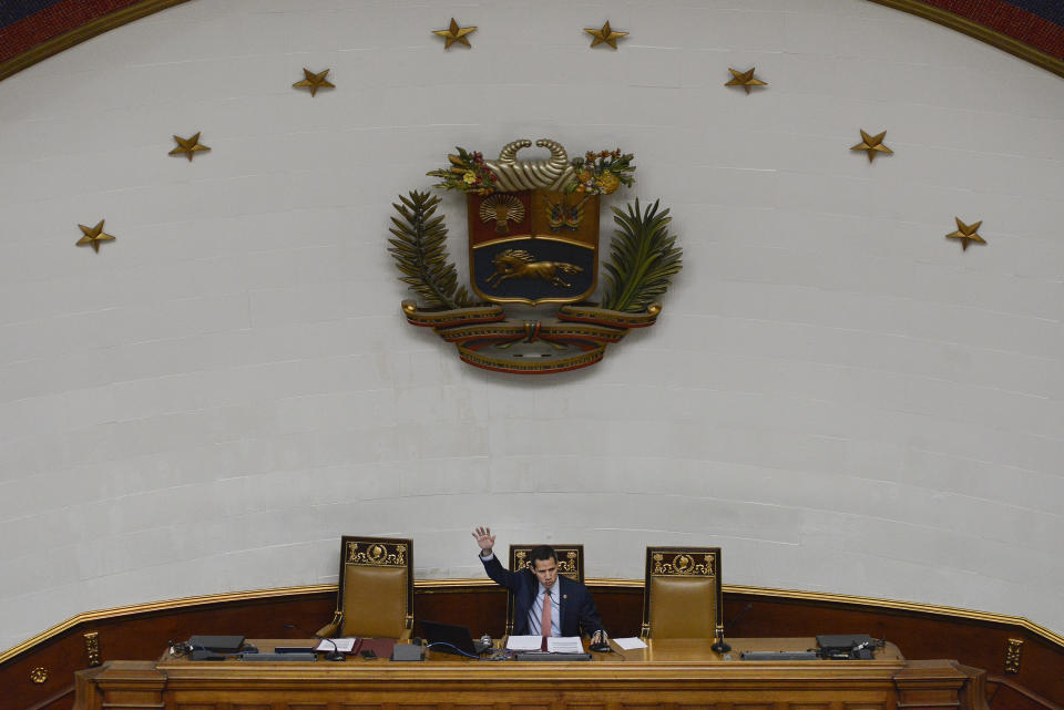 In this Dec. 17, 2019 photo, Venezuelan Opposition leader and self-proclaimed interim president of Venezuela Juan Guaido speaks during an extraordinary session at the National Assembly in Caracas, Venezuela. Cracks have appeared in Guaido's base of support in the National Assembly, the only major institution controlled by the opposition. His reelection as congressional president is no longer assured and legislators' official terms expire in a few months. (AP Photo/Matias Delacroix)