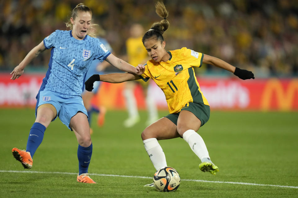 Australia's Mary Fowler, right, and England's Keira Walsh vie for the ball during the Women's World Cup semifinal soccer match between Australia and England at Stadium Australia in Sydney, Australia, Wednesday, Aug. 16, 2023. (AP Photo/Rick Rycroft)