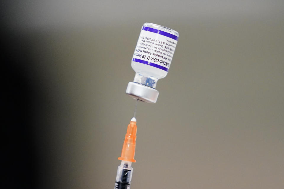 FILE - A syringe is prepared with the Pfizer COVID-19 vaccine at a vaccination clinic at the Keystone First Wellness Center in Chester, Pa., on Dec. 15, 2021. Pfizer is expected to request authorization for an additional COVID-19 booster dose for seniors. (AP Photo/Matt Rourke, File)