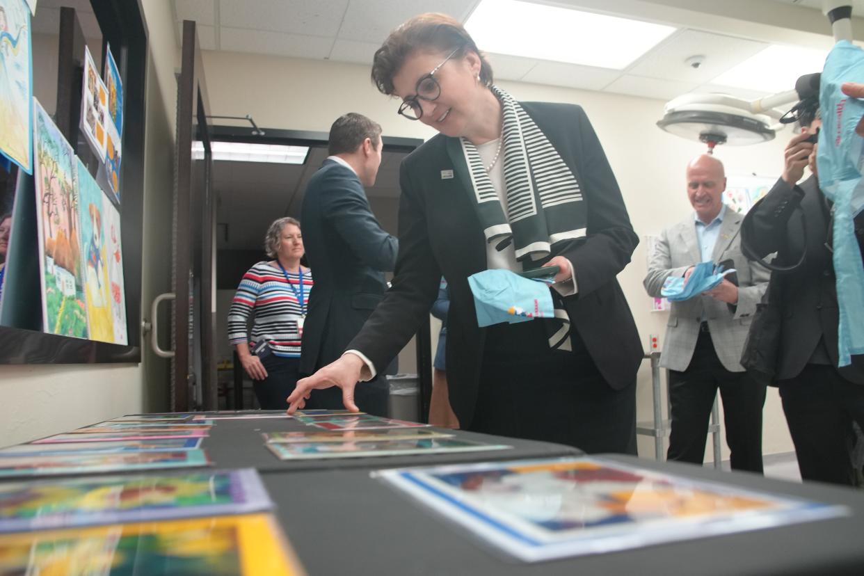 While on a tour Tuesday at the University of Oklahoma Health Sciences Center, Ukrainian diplomat Kateryna Smagliy selects a card featuring artwork by Ukrainian young people.