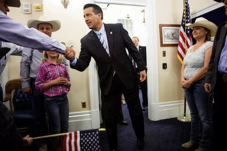 Nevada Governor Brian Sandoval greets ranching families at the Nevada State Capitol after they finished a 320-mile (515-km) relay horseback ride from Elko, Nevada to the State Capitol in Carson City to deliver a petition to him, in this May 30, 2014, file photo. REUTERS/Max Whittaker/Files