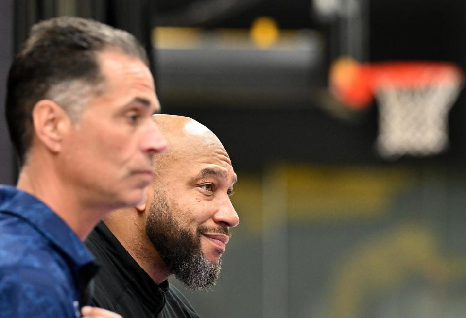 Lakers general manager Rob Pelinka, left, and coach Marvin Ham speak to the media.