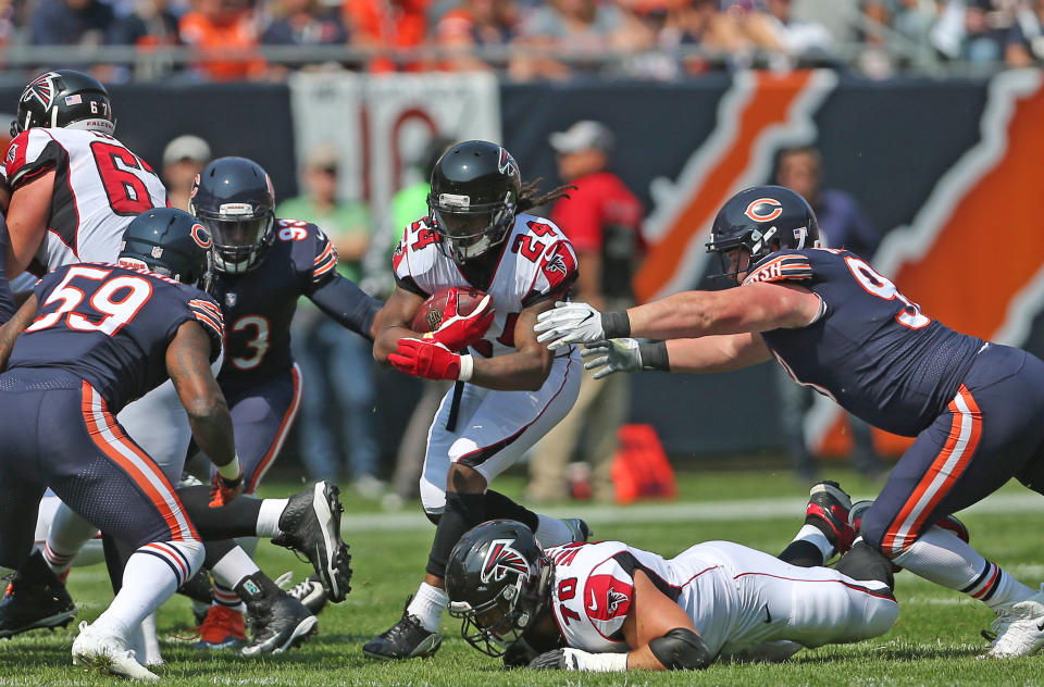 <p>Atlanta Falcons running back Devonta Freeman (24) runs with the ball during the first quarter against the Chicago Bears at Soldier Field. Mandatory Credit: Dennis Wierzbicki-USA TODAY Sports </p>