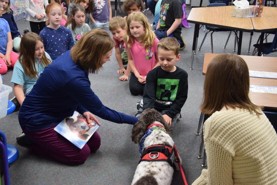 Ellis Font pets Henry during his May 5 visit to Lincoln Elementary School.