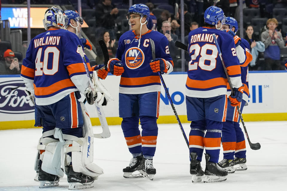 New York Islanders celebrate after defeating the Chicago Blackhawks in an NHL hockey game on Sunday, Dec. 4, 2022, in Elmont, N.Y. Islanders won 3-0. (AP Photo/Eduardo Munoz Alvarez)