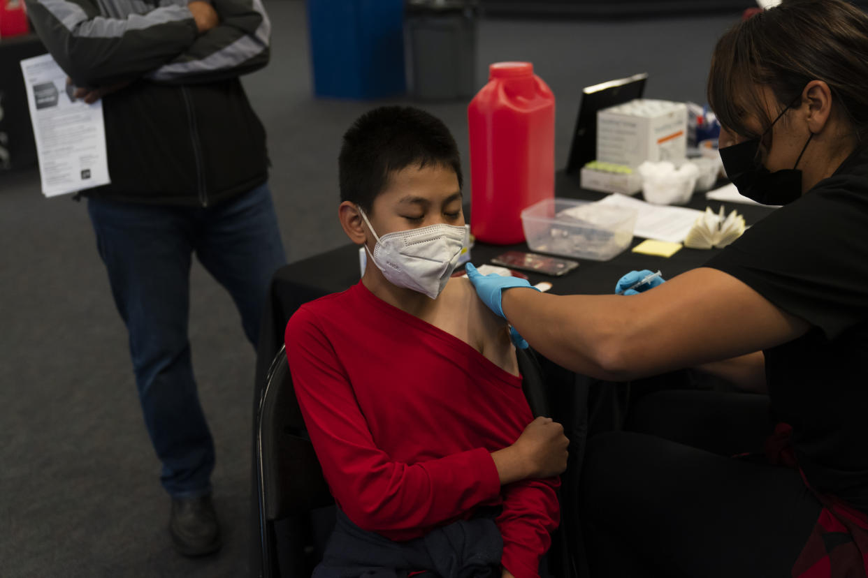 FILE - A youngster receives the Pfizer COVID-19 vaccine at a pediatric vaccine clinic for children ages 5 to 11 set up at Willard Intermediate School in Santa Ana, Calif., Tuesday, Nov. 9, 2021. State Sen. Richard Pan, D-Sacramento, announced, Thursday, April 14, 2022 that he is withdrawing his bill that would have stopped parents from getting exemptions for their child based on personal beliefs. (AP Photo/Jae C. Hong, File)