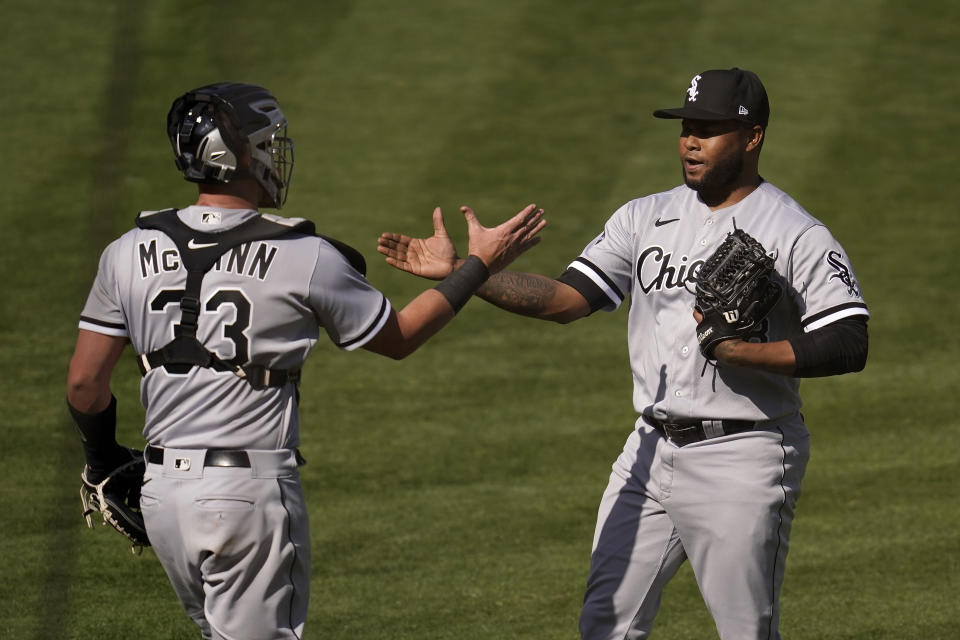 Chicago White Sox catcher James McCann (33) celebrates with pitcher Alex Colome after the White Sox defeated the Oakland Athletics in Game 1 of an American League wild-card baseball series Tuesday, Sept. 29, 2020, in Oakland, Calif. (AP Photo/Eric Risberg)