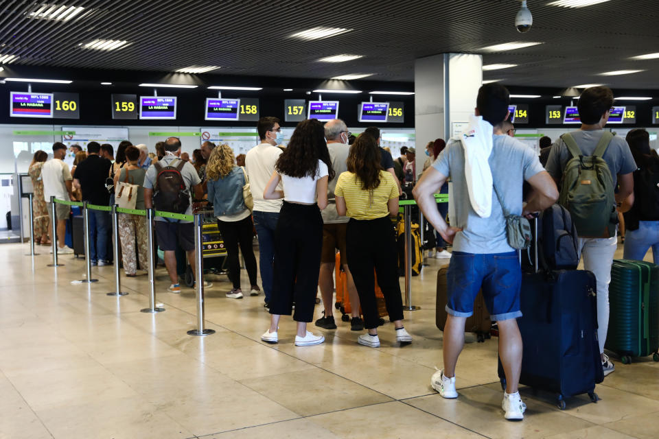 Passengers wait in the line at the Barajas Airport in Madrid on July 1, 2022. (Photo by Jakub Porzycki/NurPhoto via Getty Images)