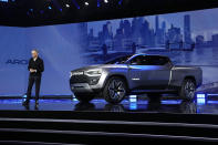 Stellantis CEO Carlos Tavares stands beside the Ram 1500 Revolution electric battery powered pickup truck during the CES tech show Thursday, Jan. 5, 2023, in Las Vegas. (AP Photo/John Locher)