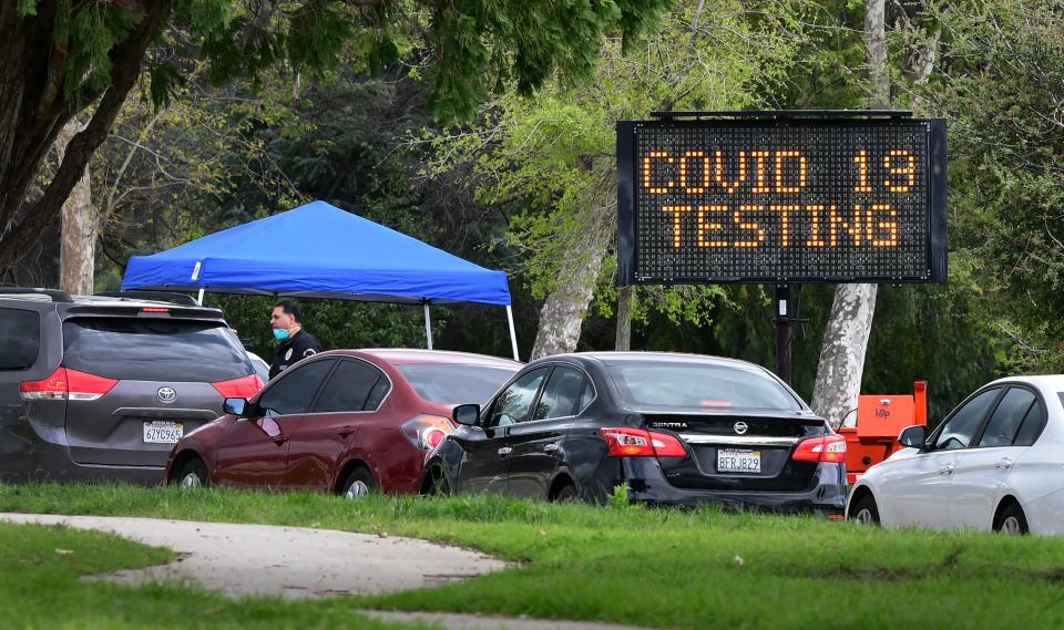 A police officer mans the entrance to a coronavirus (COVID-19) testing center in Hansen Dam Park on March 25, 2020 in Pacoima, California (Photo: FREDERIC J. BROWN/AFP via Getty Images)