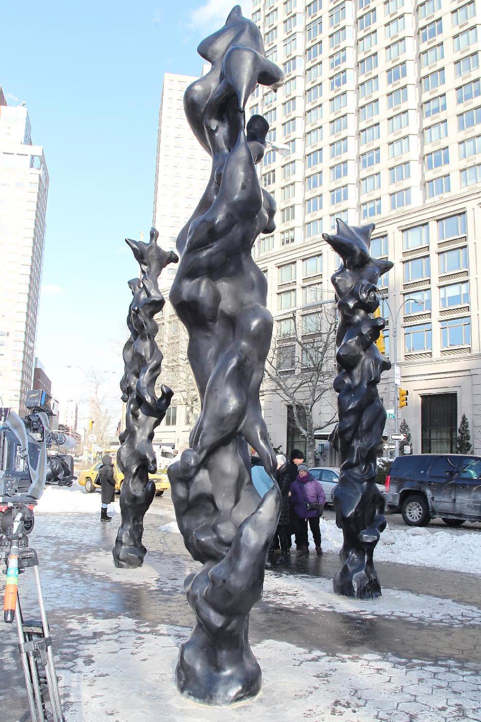 This image released by Starpix shows three black bronze totem sculptures by musician-artist Herb Alpert on display at Dante Park on west 64th Street and Broadway,Thursday, Jan 23, 2014 in New York. The sculptures will be on display until April 15. (AP Photo/Starpix, Dave Allocca)