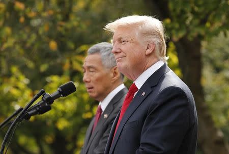 Singapore's Prime Minister Lee Hsien Loong and U.S. President Donald Trump give joint statements in the Rose Garden of the White House in Washington, U.S., October 23, 2017. REUTERS/Jonathan Ernst