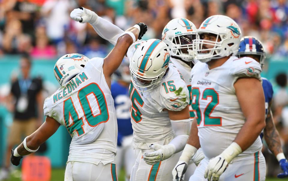 Miami Dolphins outside linebacker Jaelan Phillips (15) celebrates a sack with teammate free safety Nik Needham (40) during the second thalf of an NFL game against the New York Giants at Hard Rock Stadium in Miami Gardens, Dec. 5, 2021. 