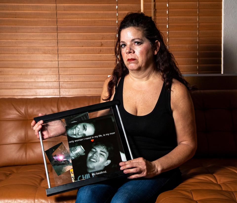 Kathy Nigro poses with a photo of her son, Michael Vasquez, at her home in Menifee.