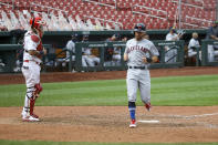 St. Louis Cardinals catcher Yadier Molina (4) watches as Cleveland Indians' Mike Freeman scores a run during the 12th inning of a baseball game, Saturday, Aug. 29, 2020, in St. Louis. (AP Photo/Scott Kane)