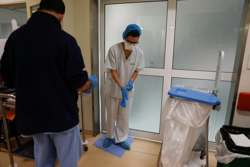 Nurse Ines Lopes leaves a COVID-19 patient room at Sao Jose Hospital in Lisbon