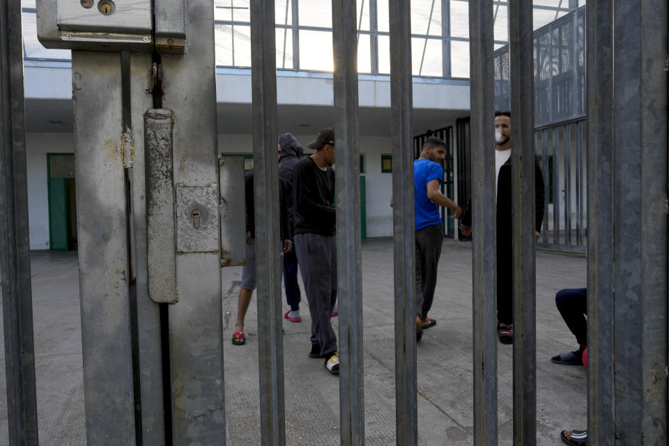 Detainees gather in an open area of the Ponte Galeria center, one of the facilities created in Italy to hold migrants ahead of their repatriation, as they are considered ineligible for refugee status or international protection, in Rome, Tuesday, March 19, 2024. (AP Photo/Andrew Medichini)