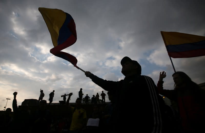 A protester waves a flag during a demonstration on Plaza de Bolivar as the national strike continues, in Bogota