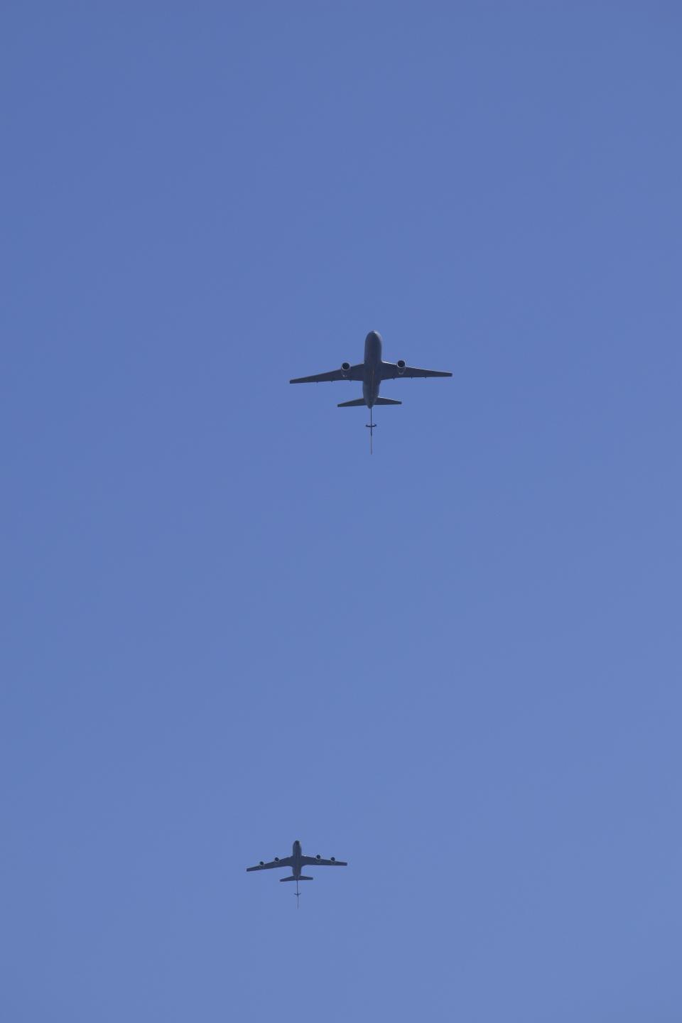 A Boeing KC-46A Pegasus flies ahead of a Boeing KC-135R Stratotanker above the Salina Regional Airport. The flyover, which saw the air refuelers, with their booms extended, drop to an altitude as low as 2,000 feet, was part of the U.S. Air Force's celebration of 100 years of air refueling.