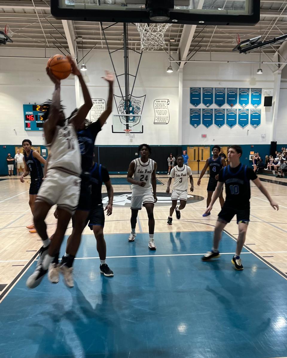 Lake Worth forward Hedrens Bartelus, who finished with a team-high 18 points, drives to the basket during the third quarter Saturday night against Wellington.