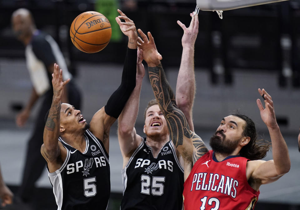 New Orleans Pelicans center Steven Adams (12) vies against San Antonio Spurs guard Dejounte Murray (5) and center Jakob Poeltl (25) for a rebound during the first half of an NBA basketball game in San Antonio, Saturday, Feb. 27, 2021. (AP Photo/Eric Gay)