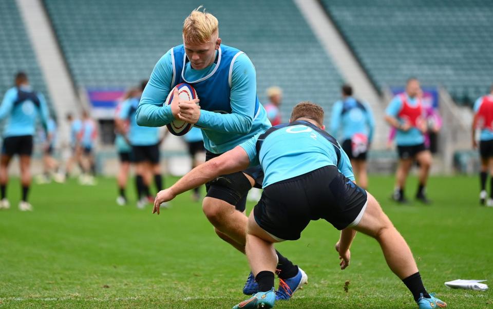 High Tizard is tackled during England training