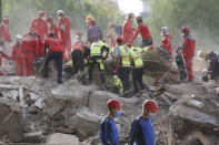 Members of rescue services search for survivors in the debris of a collapsed building in Izmir, Turkey, Monday, Nov. 2, 2020. Rescue teams continue ploughing through concrete blocs and debris of collapsed buildings in Turkey's third largest city in search of survivors of a powerful earthquake that struck Turkey's Aegean coast and north of the Greek island of Samos, Friday Oct. 30, killing dozens. Close to a thousand people were injured.(AP Photo/Darko Bandic)