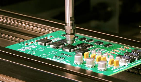 Circuit board with machinery applying adhesive