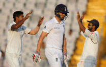 Cricket - India v England - Third Test cricket match - Punjab Cricket Association Stadium, Mohali, India - 26/11/16. India's Umesh Yadav (L) and Ajinkya Rahane celebrate the dismissal of England's Chris Woakes (C). REUTERS/Adnan Abidi